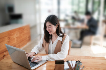 Attractive businesswoman working with laptop computer at co working space.