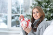 Portrait of smiling woman with Christmas gift