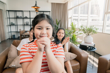 Wall Mural - happiness pleasure asian lovely family enjoy watch and cheer up little daughter girl singing and dance practice in front of tv in living room