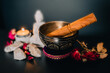 Singing bowl with Buddha candle and flowers for sound bath, relaxation and meditation