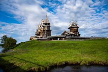 old wooden architectural complex with towers temples on a green island