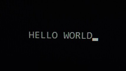 Typing hello world text on black screen close up 4k footage. Typing The Classical Programmers' Greeting Message.
