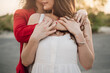 © Vane Nunes - LGBT happy lesbian couple hugging each other outdoors - Girlfriend holding each other - Focus on hands