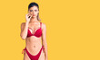 © Krakenimages.com - Young beautiful woman wearing bikini mouth and lips shut as zip with fingers. secret and silent, taboo talking