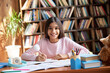 © insta_photos - Happy cute smart hispanic indian preteen kid girl student, latin child primary school pupil studying at table at home, learning sitting at classroom desk looking at camera, schoolgirl portrait.