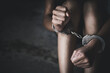 © Tinnakorn - woman hands in handcuffs, human trafficking Concept, stop violence against women and human trafficking,  international women's day.