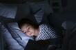 © Pixel-Shot - Little girl suffering from sleep disorder with tablet computer in bedroom