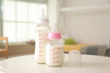 bottles of milk for baby on table in room