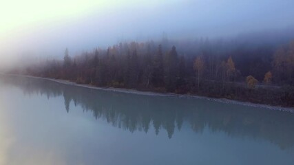 Wall Mural - Morning fog above lake and highway. Autumn in Alaska