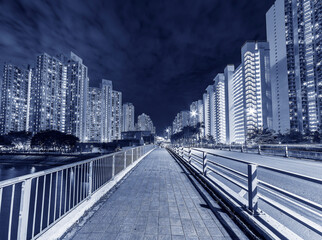 High rise apartment building and road in residential district of Hong Kong city at night