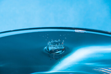 Wall Mural - Abstract an outbreak of crown water.Splash of water close up.Frozen water drop photographed at high speed.Slow dripping of liquid with air bubbles.Nature backgrounds or Wallpaper.Frozen liquid splash