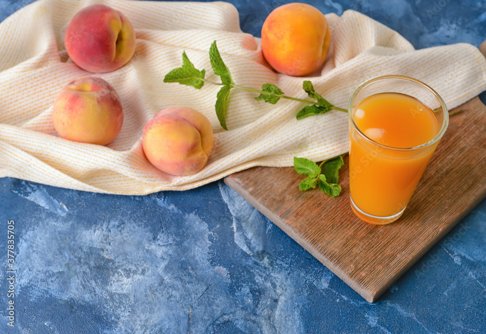 Glass of fresh peach juice on table