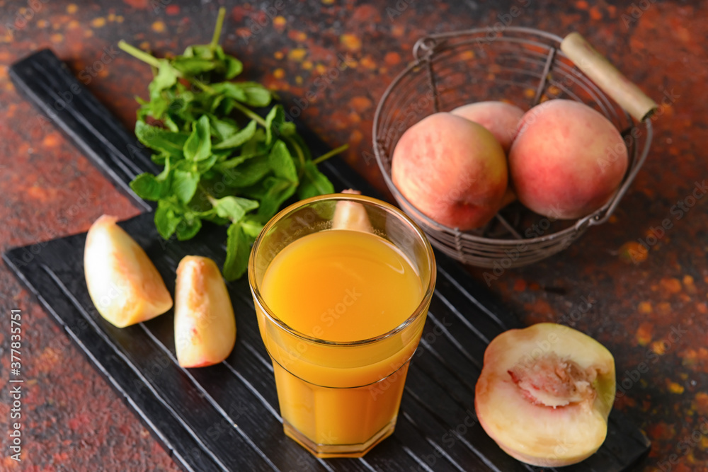 Glass of fresh peach juice on table
