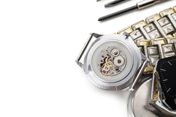 Watches and tools for repair on white background