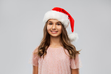 Poster - christmas, holidays and people concept - happy smiling teenage girl in santa helper hat over grey background