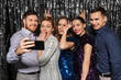 © Syda Productions - celebration, technology and holiday concept - happy friends taking selfie by smartphone at party