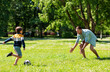© Syda Productions - family, fatherhood and people concept - happy father and little son with ball playing soccer at summer park