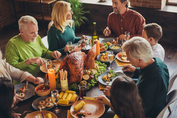 Wall Mural - Holiday feast table family relatives gathering thanks giving dinner communication living room indoors
