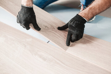 Wall Mural - The flooring foreman connects the cross locks when installing the laminate - laying the floating floor