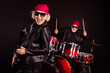 © deagreez - Photo of two retired lady man rock popular band perform concert play drum instruments solo guitar family business wear trendy rocker leather outfit bandana isolated black color background