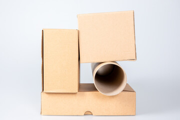 Wall Mural - Stack of cardboard boxes with card board tube on white background