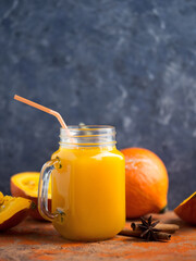 Wall Mural - Natural homemade pumpkin juice in a jar on the table with ingredients copy space