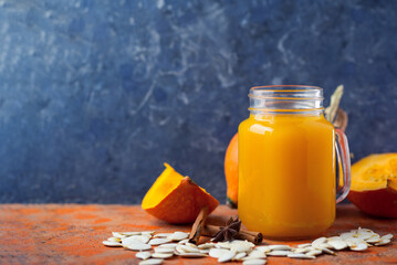Wall Mural - Natural homemade pumpkin juice in a jar on the table with ingredients copy space