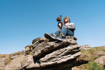 Man and dog on top of the mountain