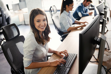 Successful happy woman working at office. Technology, computer, startup, business concept.