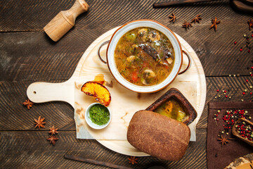 Wall Mural - Rustic mushroom soup on wooden board with bread 