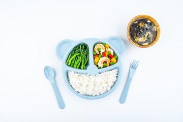 A plate of nutritious children's meal on white background