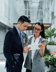 Close up portrait of smiling business people consulting using tablet stock photo