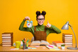 © deagreez - Photo of positive girl high school student sit table prepare exam hold clock show thumb up sign wear green sweater isolated over bright shine color background