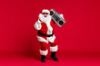 © deagreez - Full body size photo of retired old man grey beard hold boombox shoulder open mouth show horns wear santa costume sunglass headwear leather black boots isolated red color background
