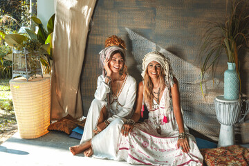 two beautiful young woman in summer dresses outdoors at sunset