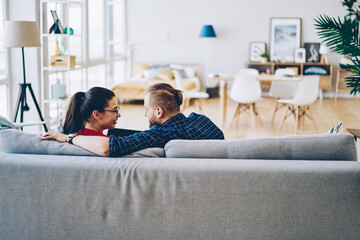 Cheerful couple relaxing together at home