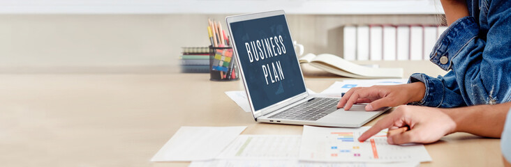 Poster - close up hand creative designer team casual meeting and brainstorming business plan with paperwork and online data on laptop in meeting room at modern office