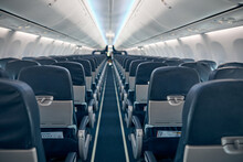 Airline Passenger Chairs And Aisle In Airplane Cabin