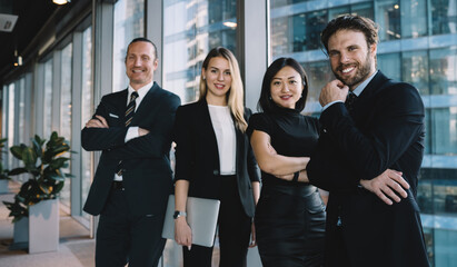 Portrait of cheerful male and female caucasian employees team in formal wear satisfied with cooperation on project company,smiling crew of professionals looking at camera standing together 