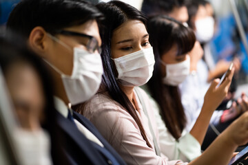 Wall Mural - Crowd of passengers on Urban Public Transport Metro. .Asian people go to work by public transport. Face Mask protection against virus. Covid-19, coronavirus pandemic