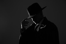 Old Fashioned Detective In Hat On Dark Background, Black And White Effect