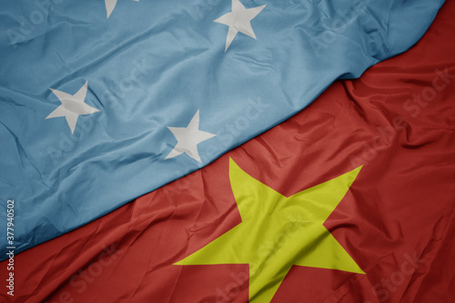 Cuadros en Lienzo waving colorful flag of vietnam and national flag of Federated States of Micronesia