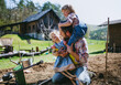 © Halfpoint - Father with small children working outdoors in garden, sustainable lifestyle concept.