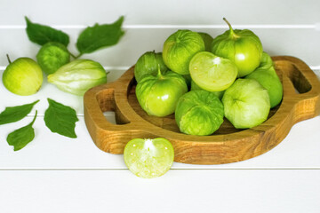 ripe vegetable fezalis in a wooden bowl on a white background. fezalis for cooking vegetable dishes close-up.