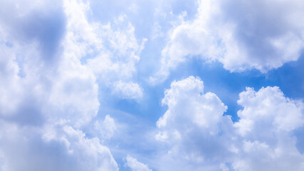 Blue sky with white fluffy cloud in a sunny day.