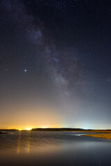 Sticker - Beautiful vertical shot of a starry night sky over the sea-perfect for wallpapers