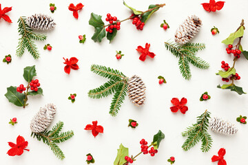 Wall Mural - christmas background with pine cones, branches of holly with red berries and fir tree on white. wint
