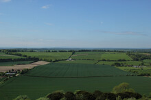 View Of Green Farmland On A Clear Sky Background