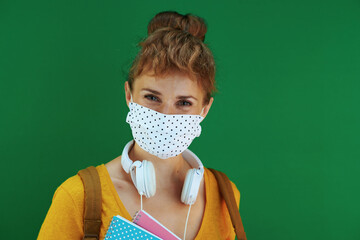 Wall Mural - Portrait of smiling modern student in shirt on green background