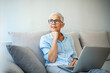 © Dragana Gordic - Shot of a mature woman relaxing on her sofa at home using a laptop. Shot of a senior woman using a laptop in a retirement home. It's never too late to join the online community